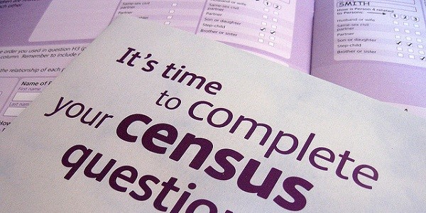Two overlaid census forms, front page of census booklet in the foregrround reads: It's time to complete your census questionnaire