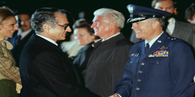 Mohammed Reza Pahlavi, Shah of Iran, shakes hands with a US Air Force general office prior to his departure from the United States. (SUBSTANDARD)