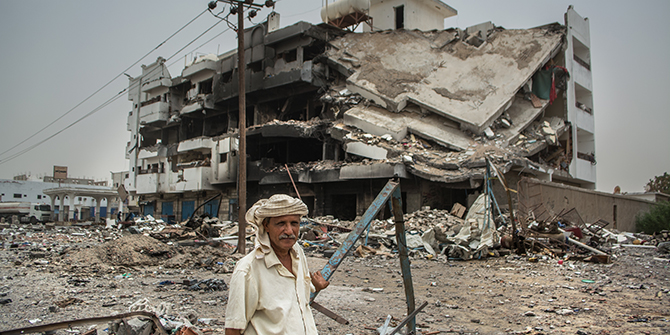 A man stands in front of his home in ruins in Aden, Lahj main road, © Karam Kamal.