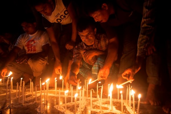 People from former Indian enclaves lit candles as they take part in the celebration at Dasiarchhara, Kurigram, Bangladesh, Aug 01, 2015.