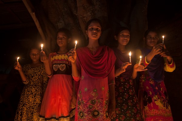 Girls from former Indian enclaves hold candles as they take part in the celebration at Dasiarchhara, Kurigram, Bangladesh, Aug 01, 2015.