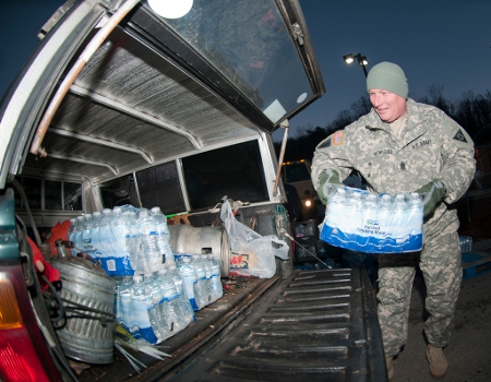 Command Sgt. Maj. Steve Deweese, of Training Center at Camp Dawson in Kingwood, W.Va., loads water into a vehicle Jan.11, 2014, at the Winfield, W.Va. Courthouse for local residents. (U.S. Air National Guard photo by Staff Sgt. De-Juan Haley) Creative Commons BY